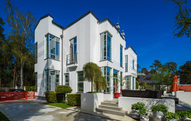 Modern exterior of luxury private house. Facade. Sunny summer day.