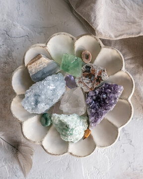 Overhead view of assorted crystals in a scalloped dish