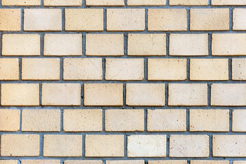 Decorative brickwork. Beige color. The facade of the building. Background or texture
