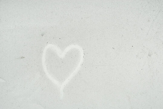 Dirt and dust texture. The heart is painted on a dirty white surface. The concept of love, romance and Valentine's Day.