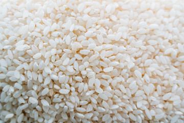 rice groats top view. White rice is shot close-up. The grains are in heaps.