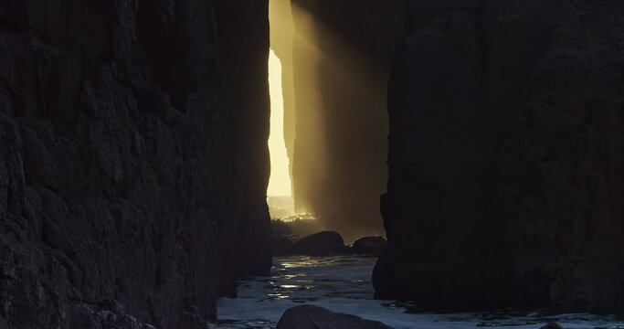 Ocean Waves Breaking Against The Zawn Pyg Rock Arch In Nanjizal Beach, Cornwall, United Kingdom. - static