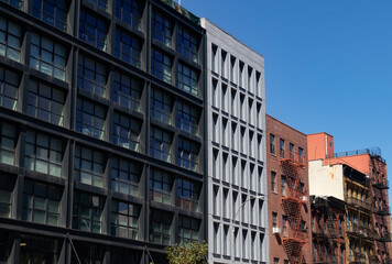 Fototapeta na wymiar Row of Modern and Old Residential Buildings along a Street in Nolita of New York City