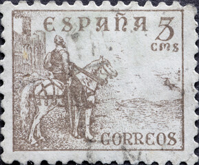 Spain - circa 1938 : a postage stamp from Spain, showing a horse with rider in full armor and...