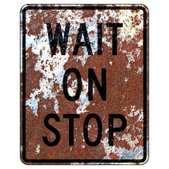 Old rusty American road sign - Wait On Stop