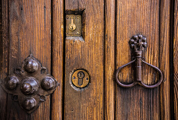 Old wooden door texture with lock and knob. Door of ancient synagogue in Toledo, Spain