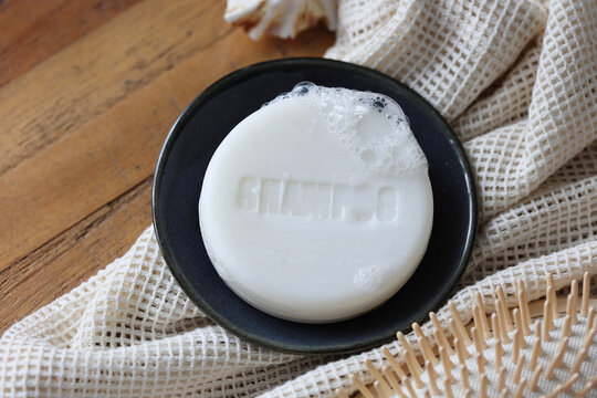 Natural et organic solid bar shampoo soap with boobles for washing hair. Zero waste, natural hair care and sustainable life. Top view.