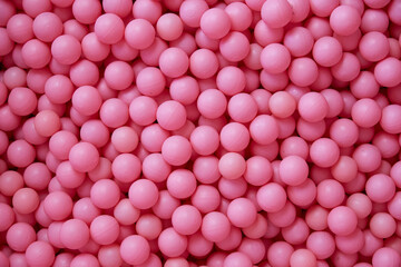 Background of pink plastic balls. Copy space.