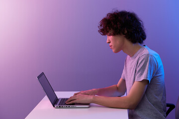 guy cyberspace playing with in front of a laptop violet background