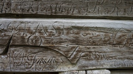 Carvings on the old wooden wall