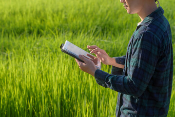 Young male smart farmer with tablet on field,High technology innovations and smart farming	