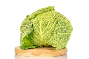 Fototapeta premium One cabbage of organic Savoy cabbage on a wooden tray, macro, isolated on white.