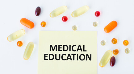 MEDICAL EDUCATION text on a yellow sticker on a white background around a scattered tablet, a methycin concept