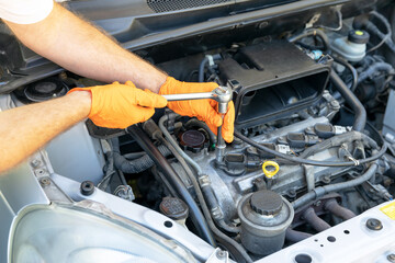 Car spark plug replacement. Repairing of vehicle.