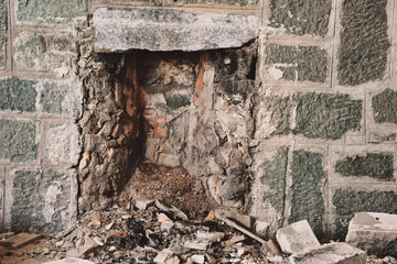 Fototapeta premium stone fireplace of an old ruined stone house, vintage