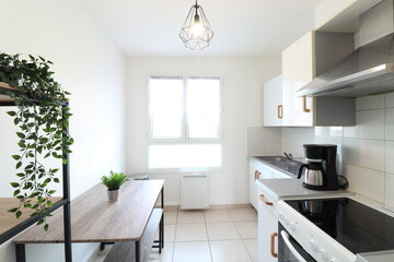 small kitchen with dining table. A coffee maker and green plants. (France - 13.10.2021)