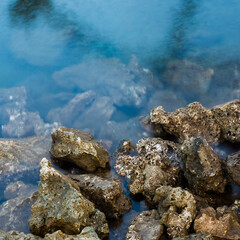 Rocks on a blue colored seawater