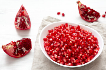 Red Pomegranate Seeds in a White Bowl , low angle view.