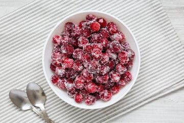 Red Sugared Cranberries in a Bowl, top view. Flat lay, overhead, from above.