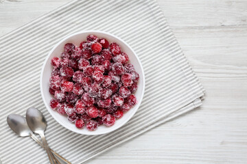 Red Sugared Cranberries in a Bowl, top view. Flat lay, overhead, from above. Space for text.