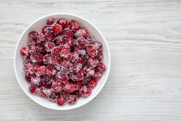 Red Sugared Cranberries in a Bowl, top view. Flat lay, overhead, from above. Space for text.