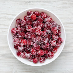 Red Sugared Cranberries in a Bowl, top view. Flat lay, overhead, from above.