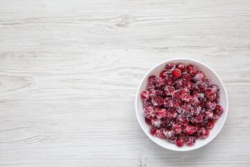 Red Sugared Cranberries in a Bowl, top view. Flat lay, overhead, from above. Copy space.