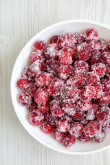 Red Sugared Cranberries in a Bowl, top view. Flat lay, overhead, from above. Close-up.
