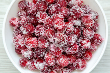 Red Sugared Cranberries in a Bowl, top view. Flat lay, overhead, from above. Close-up.