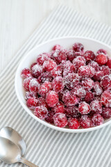 Red Sugared Cranberries in a Bowl, side view.