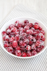 Red Sugared Cranberries in a Bowl, side view.