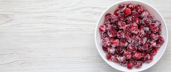 Red Sugared Cranberries in a Bowl, top view. Flat lay, overhead, from above. Copy space.
