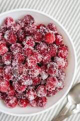 Red Sugared Cranberries in a Bowl, top view. Flat lay, overhead, from above.
