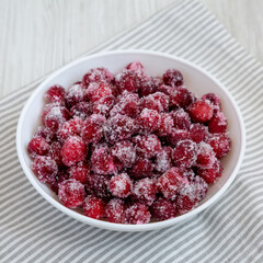 Red Sugared Cranberries in a Bowl, side view.