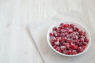 Red Sugared Cranberries in a Bowl, side view. Space for text.