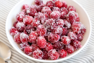 Red Sugared Cranberries in a Bowl, side view. Close-up.