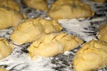 Raw pies in the cooking process.