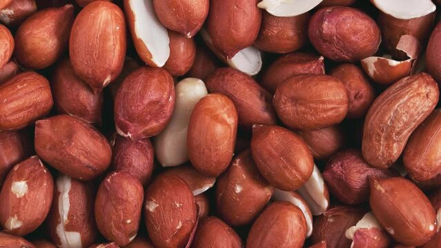 Movement of a pile of peanut kernels, without shells. Background, texture. 