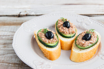 Open tuna sandwiches with cucumber point of view.