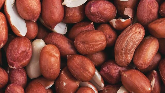 Movement of a pile of peanut kernels, without shells. Background, texture. 
