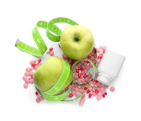 Weight loss pills, apples and measuring tape on white background, top view