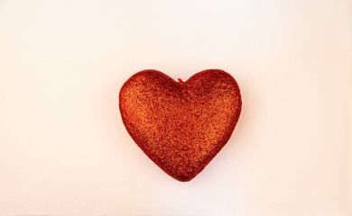 Red glitter heart on sepia background