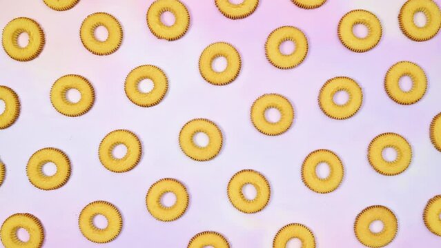 Round cookies biscuit making pattern on light purple theme. Stop motion flat lay