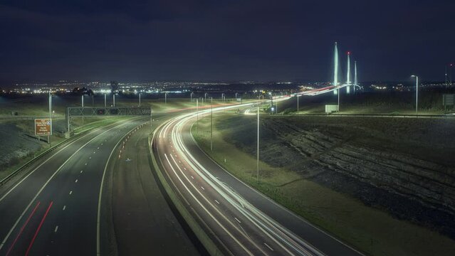Timelapse of the road leading to the big bridge and lights from cars at night. Queensferry Crossing, Scotland, United Kingdom