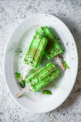 Matcha popsicles ice cream on grey background
