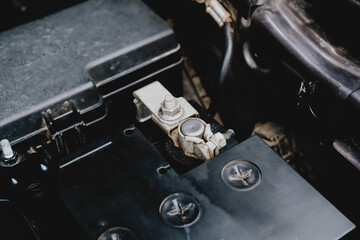 Battery cathode terminal is installed on a black battery in a electric system of car engine, Automotive electronics parts concept.