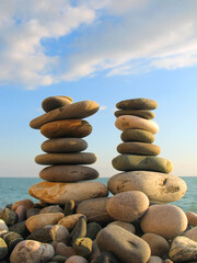 Fototapeta na wymiar Sea pebble towers on seacoast