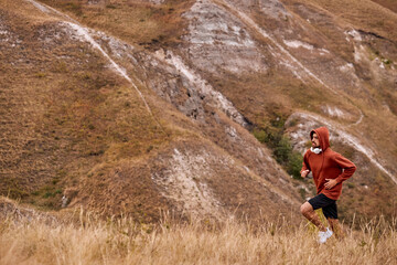 Young man running on rural field during between the summer on vacation, run for health according nature on rural, Early in the morning or on sunset or sunrise, wearing sportive clothes