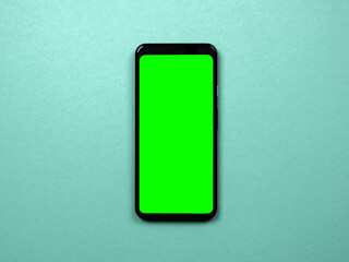 smartphone with green chromakey screen on color background