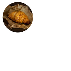 fresh baked croissant on wrapping paper. copyspace. white background.
